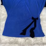 Jaclyn Smith  Blue and Black Top With a Tie Up Bow On The Side Photo 2