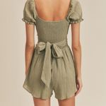 Chic Mable Tan Jumpsuit with crisscross open midriff with tie back. Size M Photo 1