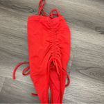 Out from under red bodysuit XS Photo 2