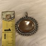 Antiqued silver tone pendant with oval shaped variegated brown stone Photo 6