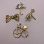 Lot Of 4 Women’s Gold Tone Brooch Pins Metal Bike, Giraffe, Umbrella, Bow Photo 0