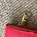 Steve Madden red leather wallet with gold zipper and snap closure, featuring card slots and coin pocket. Photo 2