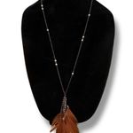 Long gold tone station bead necklace with feather tassel pendant Photo 0