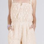 NIKIBIKI New Creamy Beige Lace Romper by  Photo 0