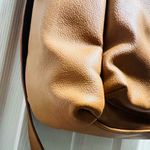 Brown patent leather diaper bag with multiple pockets and key holders Photo 2