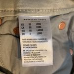 American Eagle Size 00 Super Strechy off white Jeans. Lots of Holes Photo 15
