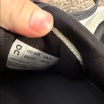 on cloud On Running women’s white sneakers with dark grey laces and neon yellow details Photo 2