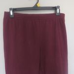 PINK - Victoria's Secret  sweatpants with pink pink on left bottom leg in burgundy red and black in small. Photo 1