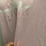 Reebok  Women's Soft Pink Tee  Chic and comfy short sleeve tee. Ideal for everyday wear.Small stains shown.  Photo 7