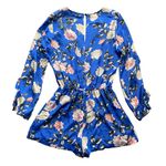 Karina Grimaldi Stunning bright blue floral romper, long sleeve with ruffle front of romper is lined and the bottoms are lined, elastic waistband, 70% silk and 30% viscose, perfect condition, size large Measurements: Bust: armpit to armpit 21 inches  Waist: side to side 14-17 inches  Length: shoulder seam to bottom 32 inches Photo 3