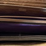 Coach  signature Charlie C zip around wallet gold with purple interior Photo 15