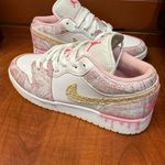 Nike  Pink and White Sneakers with Gold Accents Photo 1