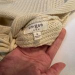 Umgee  cream colored v-neck lace up back long sleeve sweater. Photo 3