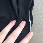 Nike Gap Fit gfast zip pocket Capri in true black Photo 3