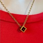 Beautiful Gold Necklace with a Ruby Colored Stone Photo 1
