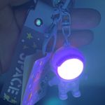 Cute cartoon Astronaut with the sunset light keychain Purple Photo 0