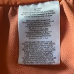 BCB GENERATION-SUMMER DRESS WITH CUTOUT-SIZE 2 Beautiful orange rust color dress, elastic waist, front cutout, back zipper, 100% polyester, excellent condition Measurements: Bust: armpit to armpit 16 inches Waist: side to side 14 inches Length: shoulder seam to bottom 32 inches Photo 6