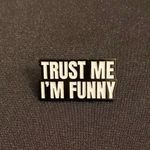 Enamel pin or magnet demands attention but not sure these go together logically Black Photo 0