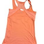 Adidas Stay stylish and comfortable with the  Women's Orange Tank Top. Perfect for workouts or casual wear, this top offers a vibrant look and a great fit. Photo 3