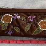 Avon NWOT Y2k chocolate brown clutch with floral design. Photo 6