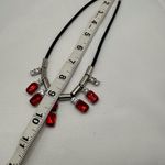 Beautiful necklace with red stones and diamonds in a black background Photo 1