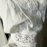 Rose & Grey LOS ANGELES white lace V-neck long sleeve shirt top peplum tie cuff  New with tag  Smoke and pets free  Same day shipping Elevate your wardrobe with this stunning white lace blouse from . The V-neckline and long sleeves add a touch of elegance to this top, while the peplum and tie cuff details create a flattering silhouette. The angel character and rose theme make it perfect for any occasion, from casual outings to formal events.   Crafted from high-quality lace fabric, this blouse features adjustable features and is available in size S. The solid pattern and delicate lace accents make it a versatile piece that can be paired with any bottom. Whether you're dressing up or down, this  blouse is sure to turn heads. Photo 6