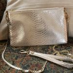 Charming Charlie Blush Metallic Snakeprint Crossbody Wristlet from Photo 0