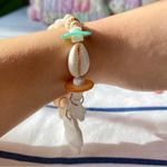 painted seashell and puka shell bracelet with charms Photo 1