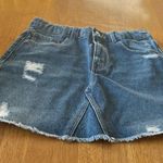 ZARA denim mini skirt, size 11/12. It is slightly distressed with a raw hem. Photo 0