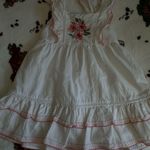 Charming white dress with pink floral embroidery. Features ruffled sleeves and hem. Perfect for casual outings. Size none Photo 8