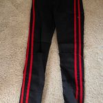 Black Jeans With Red Stripes Down Leg Photo 0