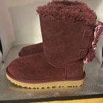UGG  snow boots size women’s five. Absolutely adorable burgundy color with bows.​ Photo 3