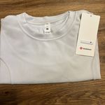 Lululemon Softstreme Gathered T-Shirt  Peach-fuzz soft texture Feels smooth next to skin Four-way stretch Quick-drying Weighty drape Machine washable. Water drops can easily mark this fabric—a simple wash will remove them  ColourLight Vapor Photo 4