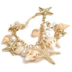 Jewelry by Lyra Beachy gold and white charm bracelet with starfish and seashells. NWT Photo 0