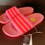 Adidas ADILETTE COMFORT K sandals pink orange super soft comfy light weight NWT New with tag Same day shipping Smoke and pets free Get ready to step up your style with these Adilette Comfort K sandals! These sandals are perfect for those who want to look fashionable while staying comfortable. With a super soft and lightweight design, these sandals are perfect for all-day wear. The pink and orange striped pattern adds a pop of color to your outfit, making them a great choice for any occasion. These sandals come in a UK shoe size 5, US shoe size 5, and EU shoe size 37. The synthetic upper material and comfort slide product line ensure that your feet will stay cool and comfortable no matter where you go. Don't miss out on the chance to add these stylish and comfortable sandals to your shoe collection! Photo 0