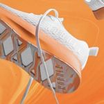 Nobull Journey running shoe in white with an orange midsole Photo 1