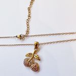 Cherry charm on a gold necklace Photo 1