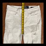 Hollister White high-rise Super Skinny Rugged ripped Jeans - size 5 reg. Junior. Gently warn and excellent rugged condition. Measurements approximately 14” waste x 38 1/2” long x 10” rise. Non smoking home. priced to sell at as is condition. Don’t like my price, make reasonable offer! And thank you for checking my closet. Photo 7