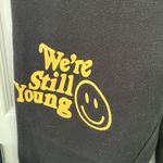 We’re Still Young Fanjoy black sweatpants yellow smiley face size small pockets Photo 1