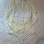 Bebe White Lace Sheer Long Sleeve Bodysuit. Size: Medium. Photo 6