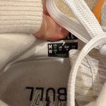 Nobull Journey running shoe in white with an orange midsole Photo 5