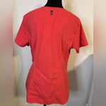 Grey's Anatomy V-Neck Short Sleeve scrub Top in Coral/orangish. Size Medium. Photo 4