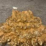 Stacees Shine in this elegant gold lace dress, perfect for any special occasion. The intricate lace detailing adds a touch of sophistication. Photo 6