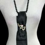 “Dainty Dapper” Black necktie Necklace with Gold and Pink Accent serpent pin. Photo 0