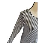 Michael Kors beautiful tunic top, black and white stripes. Long sleeves, lightweight, two tier ruffle bottom, excellent condition, size medium Measurements: Bust: armpit to armpit 20 inches Length: shoulder seam to bottom 29 inches Photo 4
