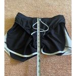 Under Armour  HeatGear Running Shorts Black White Women’s M Medium Loose Fit Photo 5