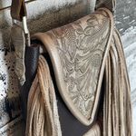 Deep brown and golden browns are stunning on this leather crossbody purse. Photo 2