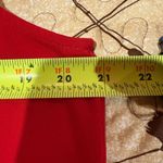 Calvin Klein 's sleeveless red top features a black tie neckline Photo 6