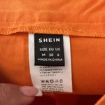 SheIn orange pants with hip cut out Photo 5