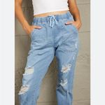 Unlisted Women’s distressed denim joggers size small Photo 1